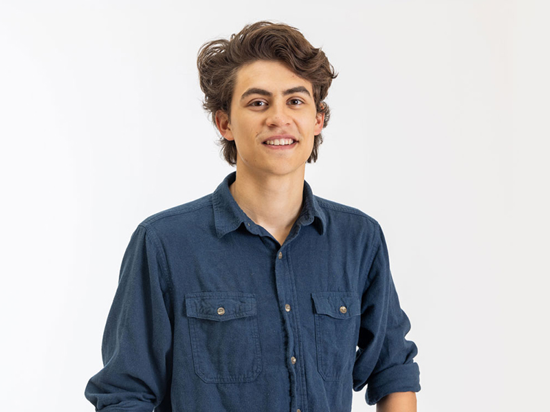 A portrait of Caz Barnum wearing a dark blue button down shirt.