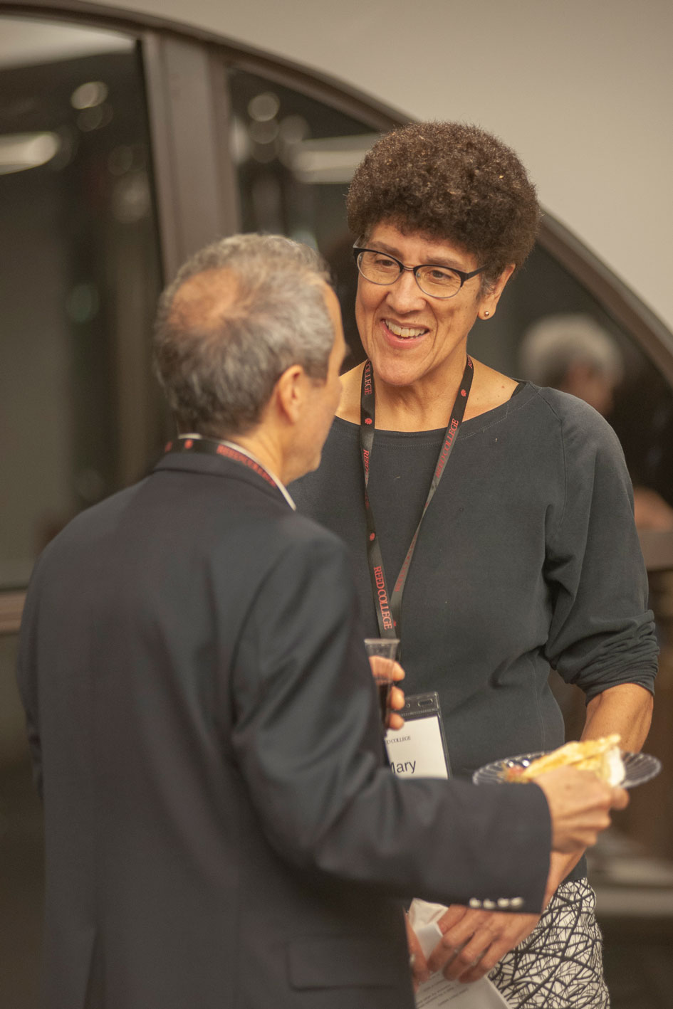 Mary James speaking with a man